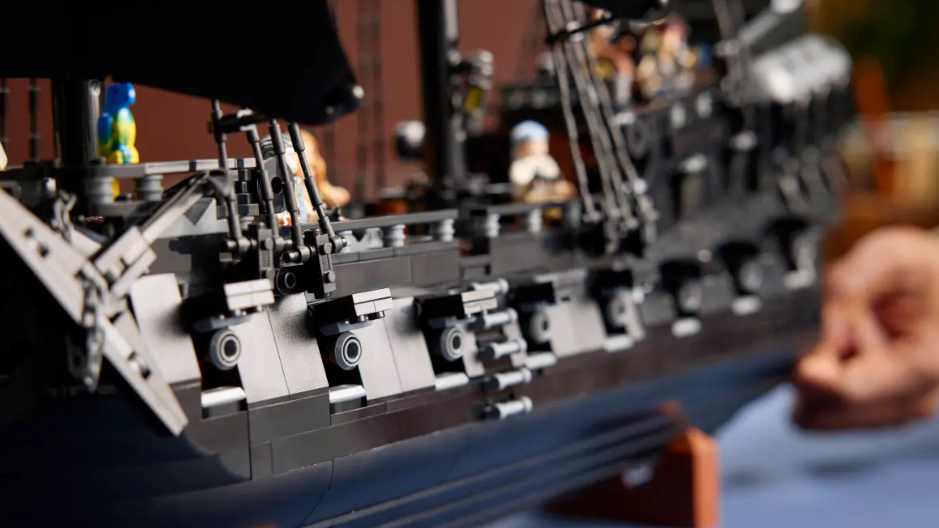 A closeup look at the side of Lego Captain Jack Sparrow's Pirate Ship, with the hatches raised and cannons showing