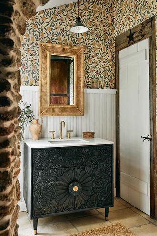 Decorated bathroom with wallpaper and black wooden sink