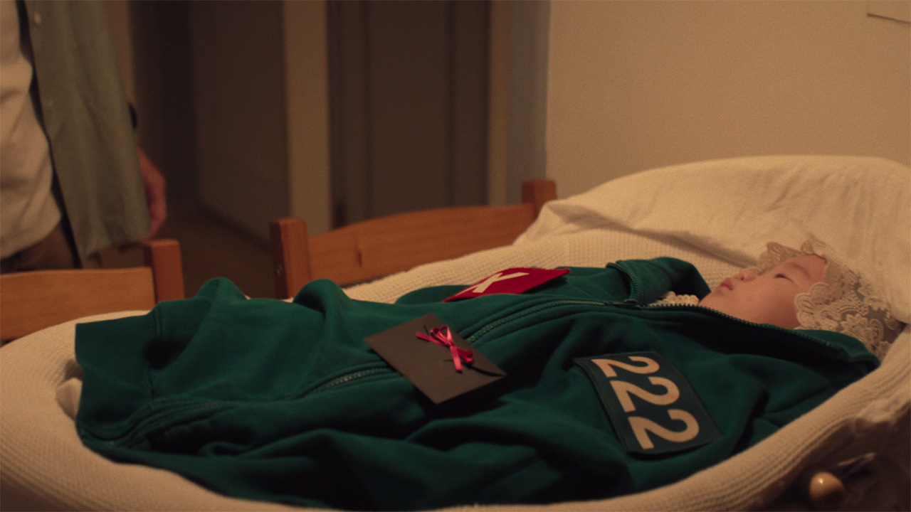 Jun-hee's baby wearing its mom's Squid Game top while in a crib in Squid Game season 3