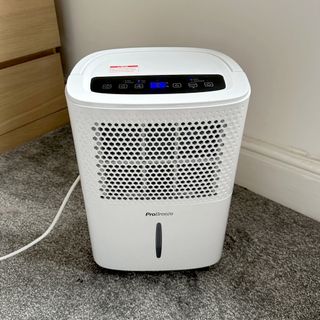The Pro Breeze 12L Low Energy Dehumidifier review being tested in a carpeted room