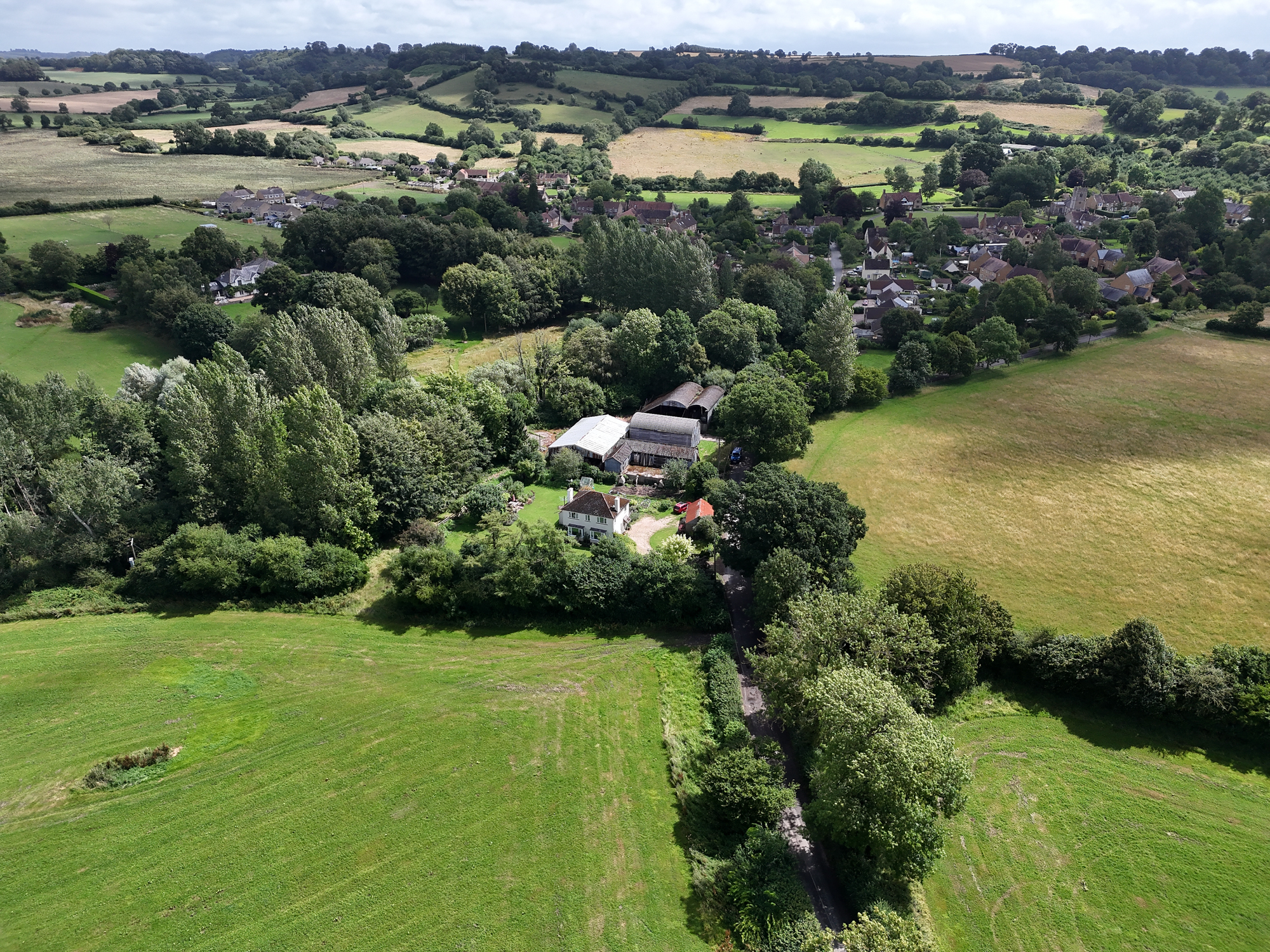 DJI Air 3 aerial photo of a rural home on a sunny day with the 24mm wide camera