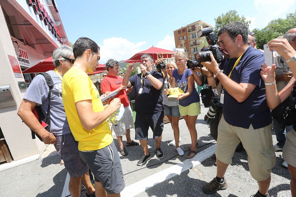 Alberto Contador signs autographs.