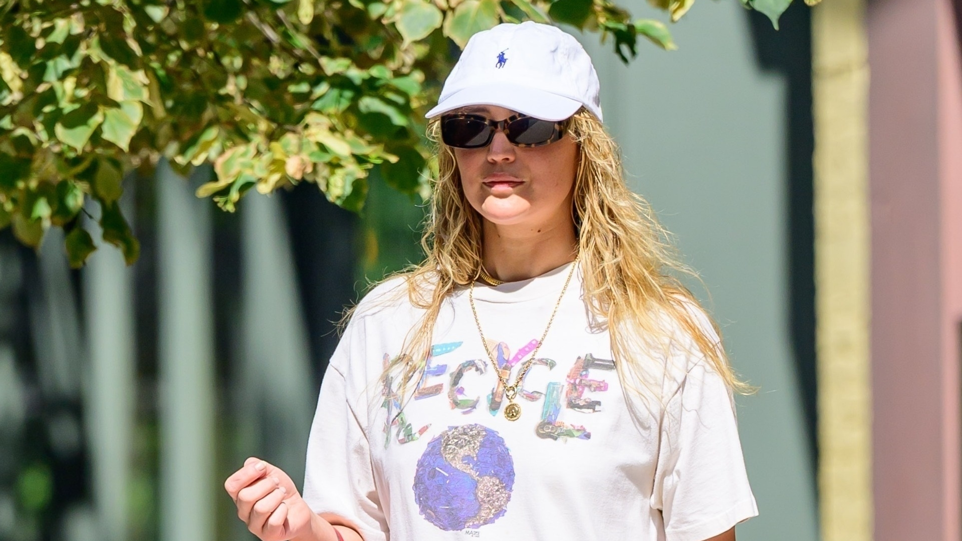 Jennifer Lawrence pulls off toe ring sandals with an all-white street style look in NYC.