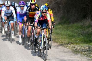 Tiffany Cromwell leading the peloton on the gravel roads of Strade Bianche 2022