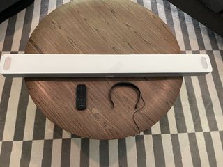 Bose Smart Soundbar 900 and accessories placed on wooden table top