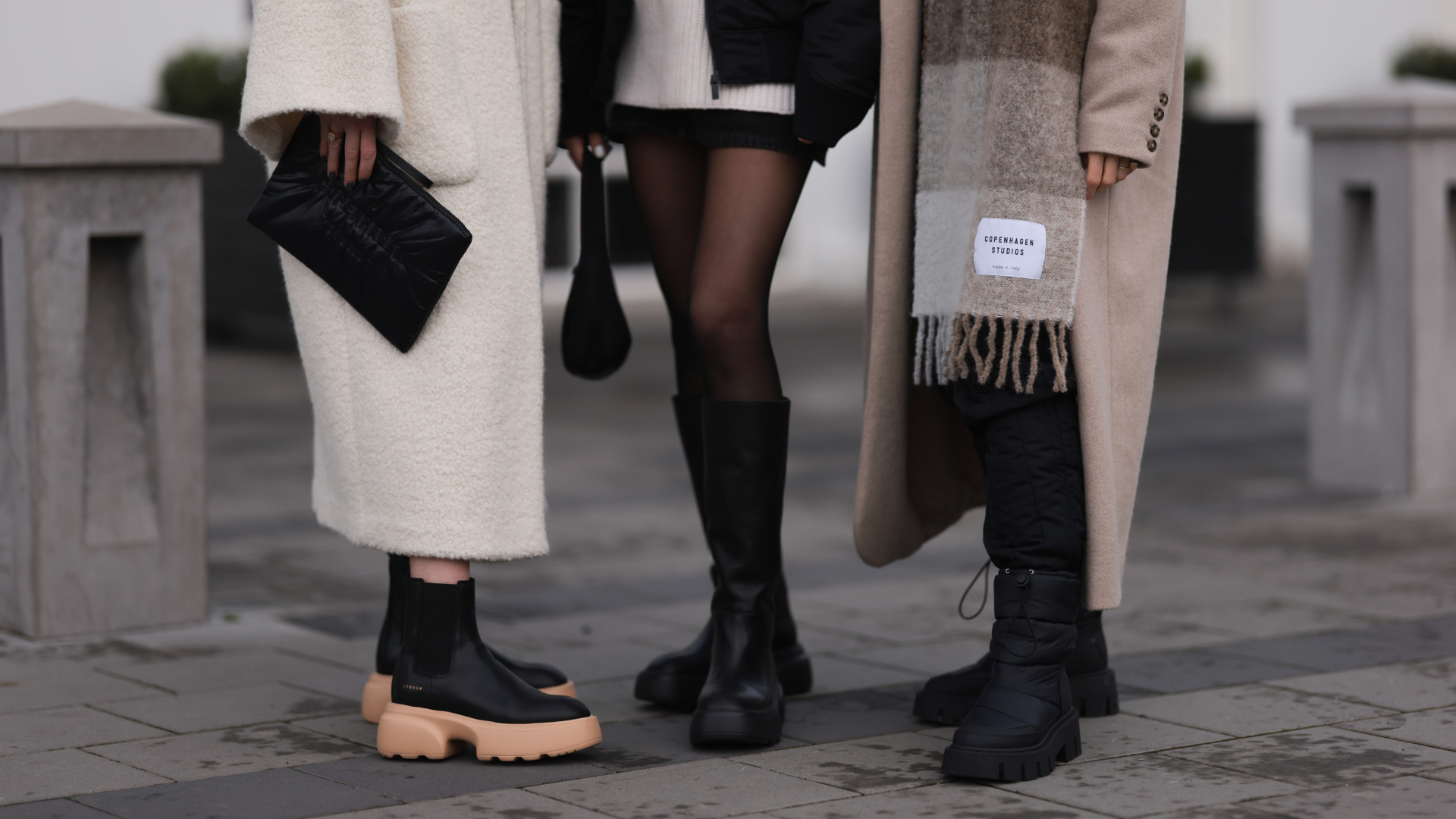 Annabel Rosendahl (L) is seen wearing Copenhagen Studios CPH 276 Vitello black/ pale beige boots, Copenhagen Studios black clutch bag and Dorothee Schumacher creme white wool coat; Marie Hindkaer (M) is seen wearing a black Prada nylon bag, black leather Copenhagen Studios CPH145 boots, creme white Samsoe Samsoe knit sweater, Acne Studios black short skirt and a black Jw Anderson x Uniqlo jacket; Mie Juel (R) wears Copenhagen Studios beige wool scarf, Copenhagen Studios CPH149 black boots, Birgitte Herskind beige wool coat and black Basic Apparel pants, on November 15, 2022 in Reykjavik, Iceland. (Photo by Jeremy Moeller/Getty Images for Copenhagen Studios)