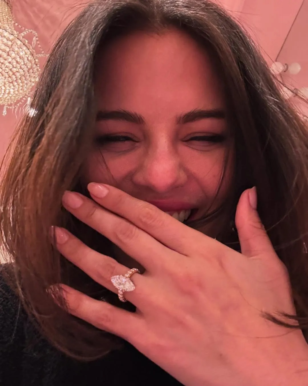 Woman wearing engagement ring on her hand.