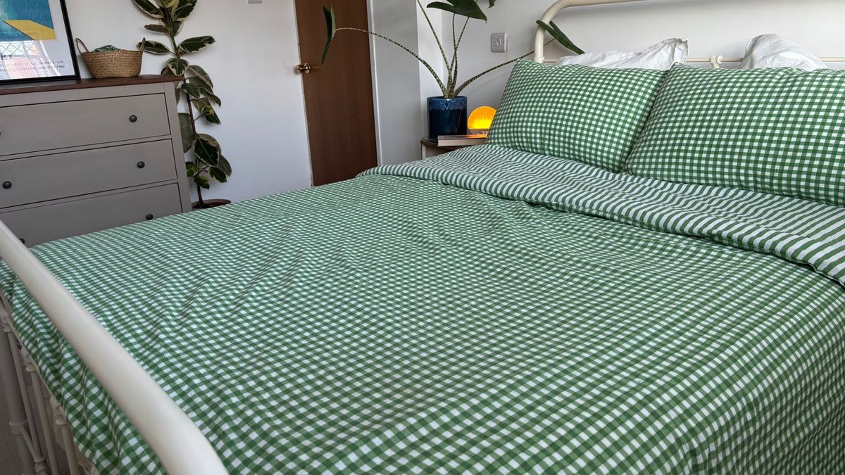 The image shows the Birch Elite Natural mattress dressed in green and white gingham bedding, placed inside a neutrally decorated bedroom