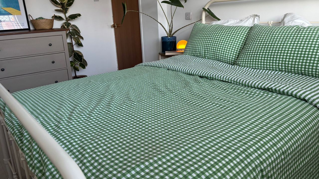 The image shows the Birch Elite Natural mattress dressed in green and white gingham bedding, placed inside a neutrally decorated bedroom