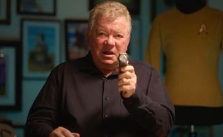 William Shatner aims a sci-fi phaser weapon