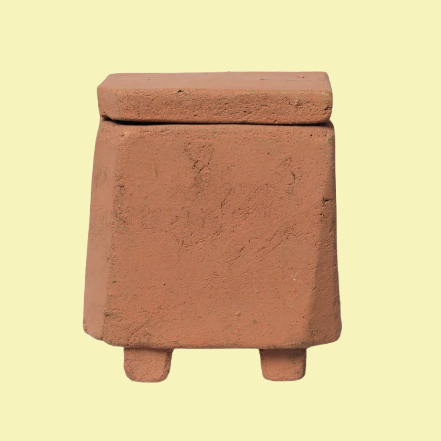 A scented candle in a terracotta vessel