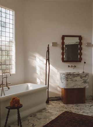 A spa bathroom with marble and hardwood