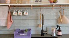 A modern kitchen with lilac kitchen storage basket and hanging utility rail