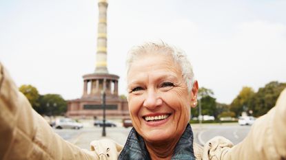 A retired woman takes a selfie on a European vacation.