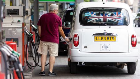 Taxi driver filling up with fuel