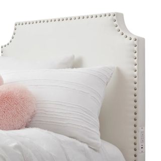 A plush white headboard with pillows