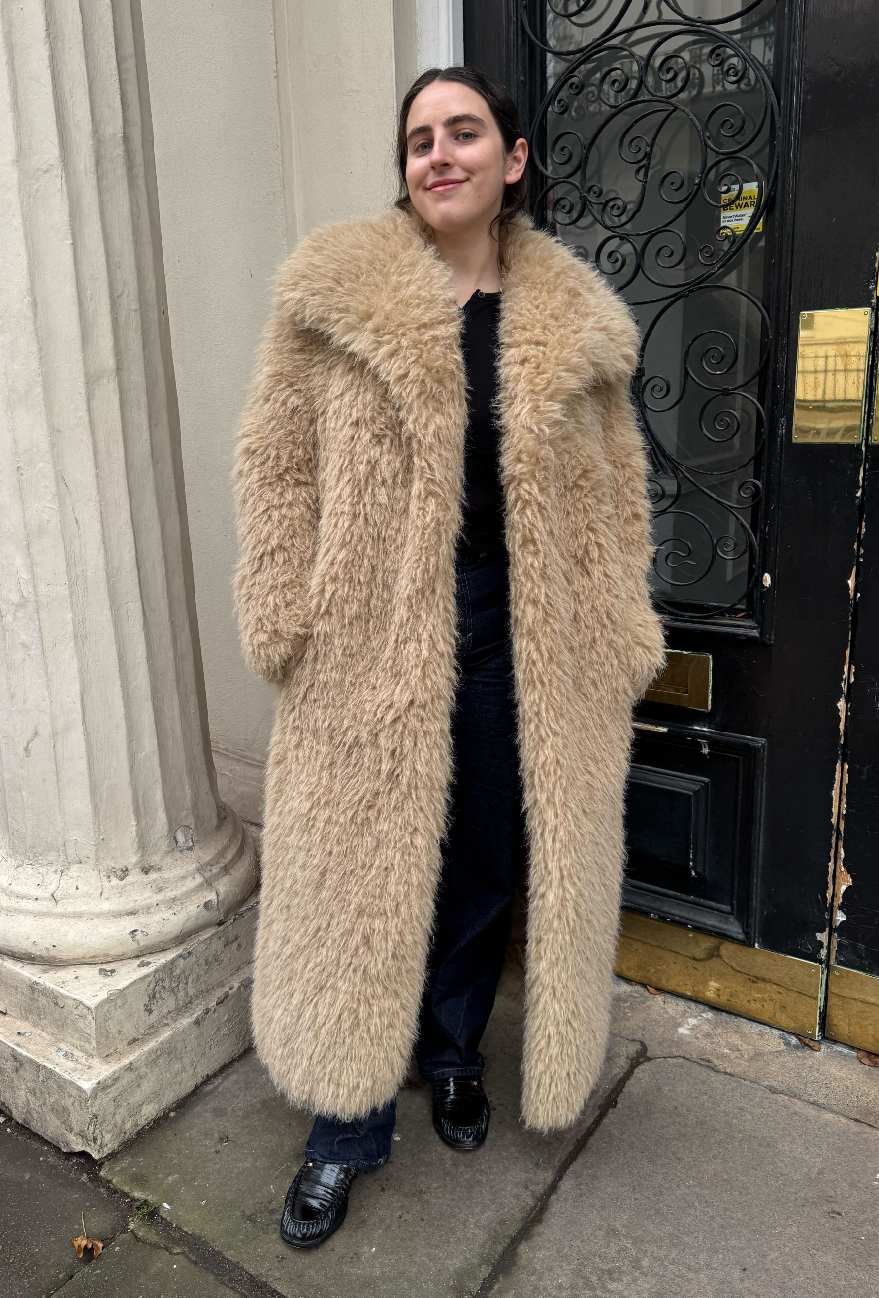 An editor from Who What Wear UK modelling a teddy coat