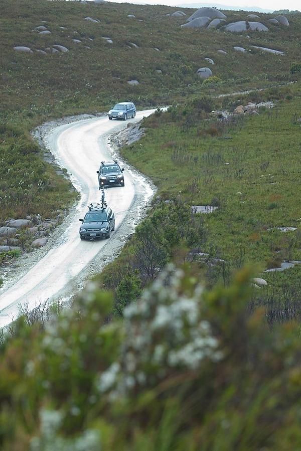 Support crews roll along the serpentine track into remote Trial Harbour.