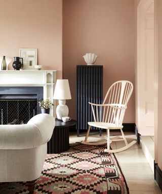 Pink painted living room with black and white furnishings