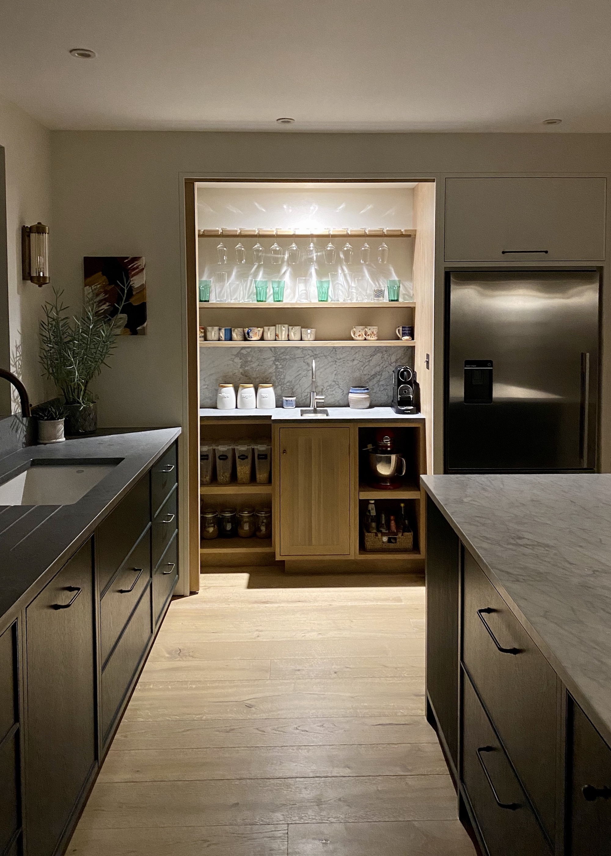 dark kitchen with lit drinks area/pantry