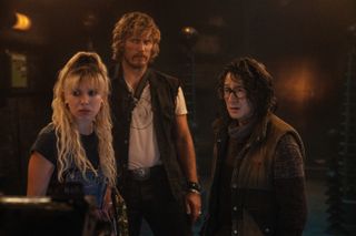 millie bobby brown chris hemsworth and ke huy quan styled in 90s action clothing in the movie the electric state