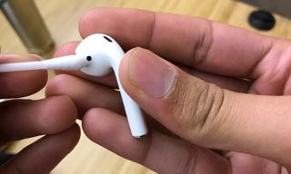 Cleaning AirPods with cotton bud