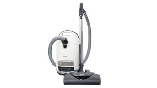 A Miele Complete C3 Cat and Dog Powerline Canister Vacuum against a white background