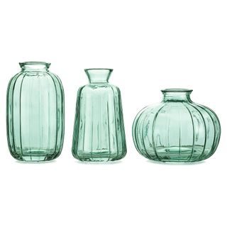 A set of three green glass mini vases