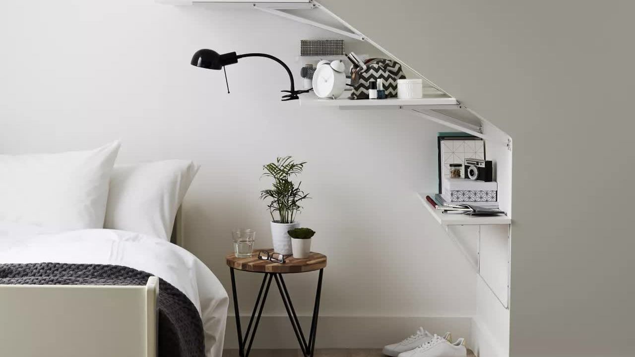 B&amp;Q B&amp;Q Goodhome Cleveland grey paint used in a bedroom with shelves, a bedside table and a bed