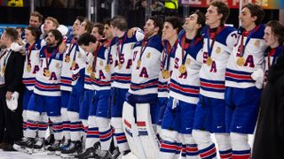 Players of Team USA stand with their gold medals after their win against Switzerland in the 2025 Ice Hockey World Championship match between Switzerland and USA