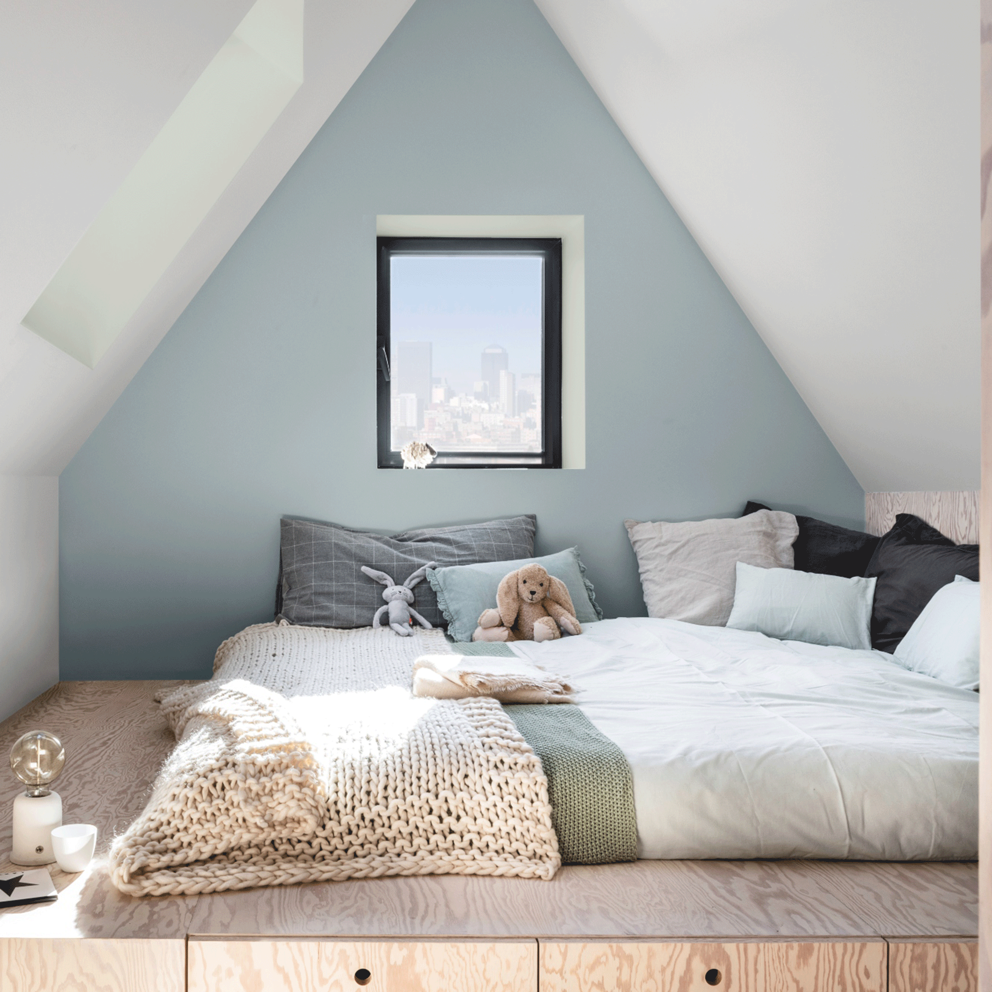 Blue kids attic room with bed