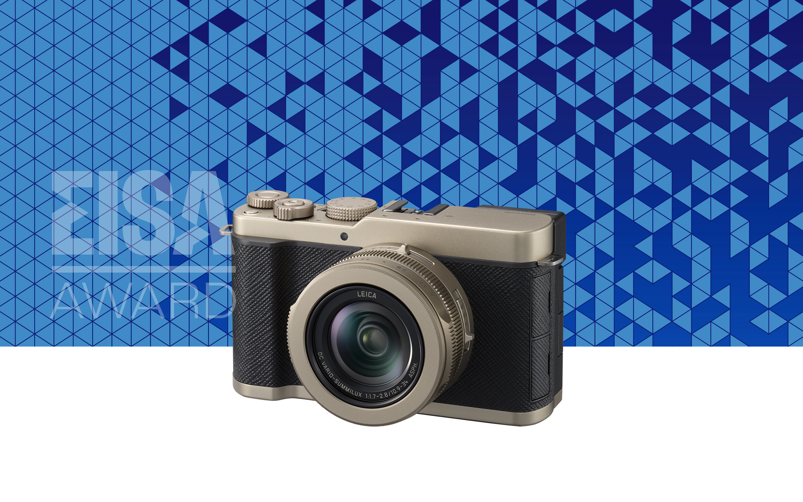 Compact Leica camera with metallic and black body in front of a blue geometric patterned background with "EISA Award" text