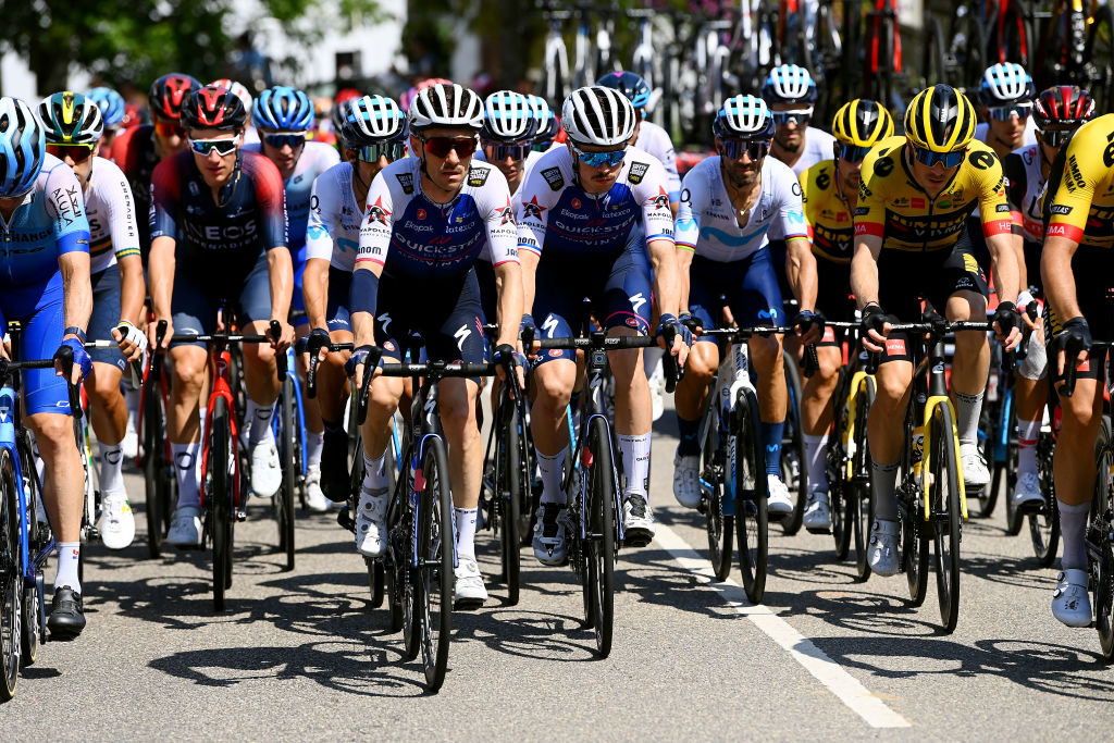 LES PRAERESNAVA SPAIN AUGUST 28 LR Dries Devenyns of Belgium Rmi Cavagna of France and Team QuickStep Alpha Vinyl and Rohan Dennis of Australia and Team Jumbo Visma compete during the 77th Tour of Spain 2022 Stage 9 a 1714km stage from Villaviciosa to Les Praeres Nava 743m LaVuelta22 WorldTour on August 28 2022 in Les Praeres Nava Spain Photo by Tim de WaeleGetty Images