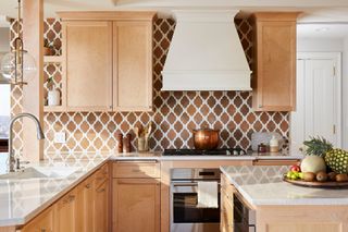 Kitchen with wood units and terracotta tile backsplash