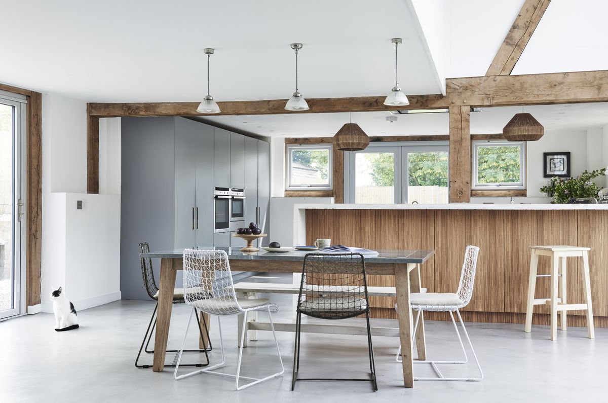 blue and wood kitchen with dining area