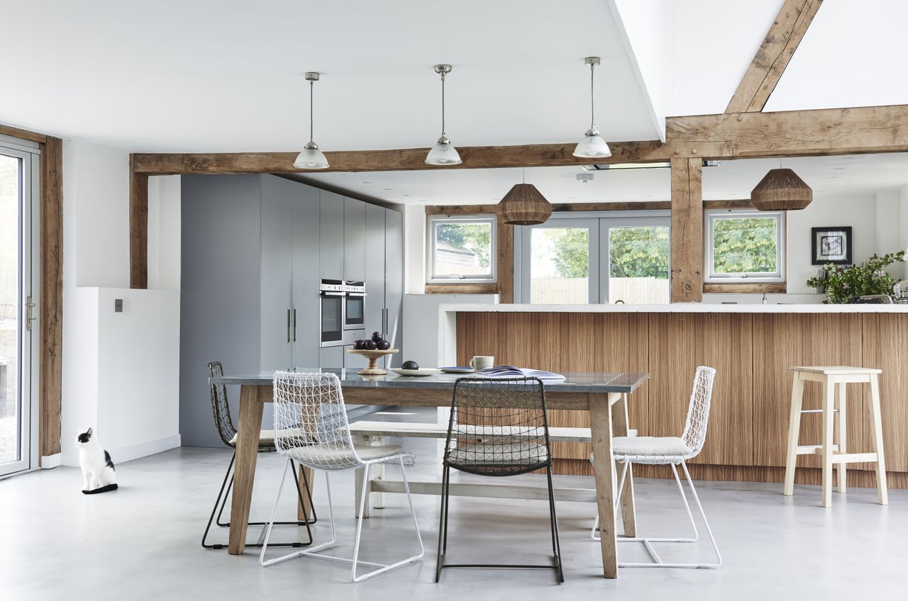 blue and wood kitchen with dining area