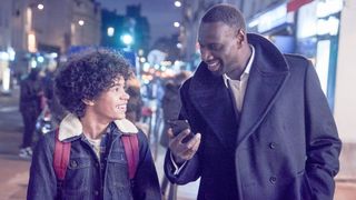 Etan Simon as Raoul and Omar Sy as Raoul's father, Assane Diop, in the Netflix series "Lupin."