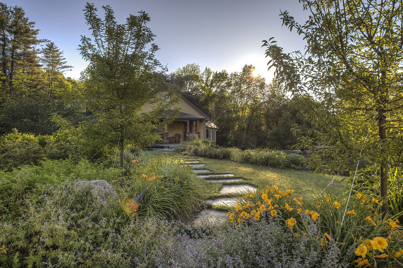 tree landscaping ideas with crab apple trees either side of a stone path