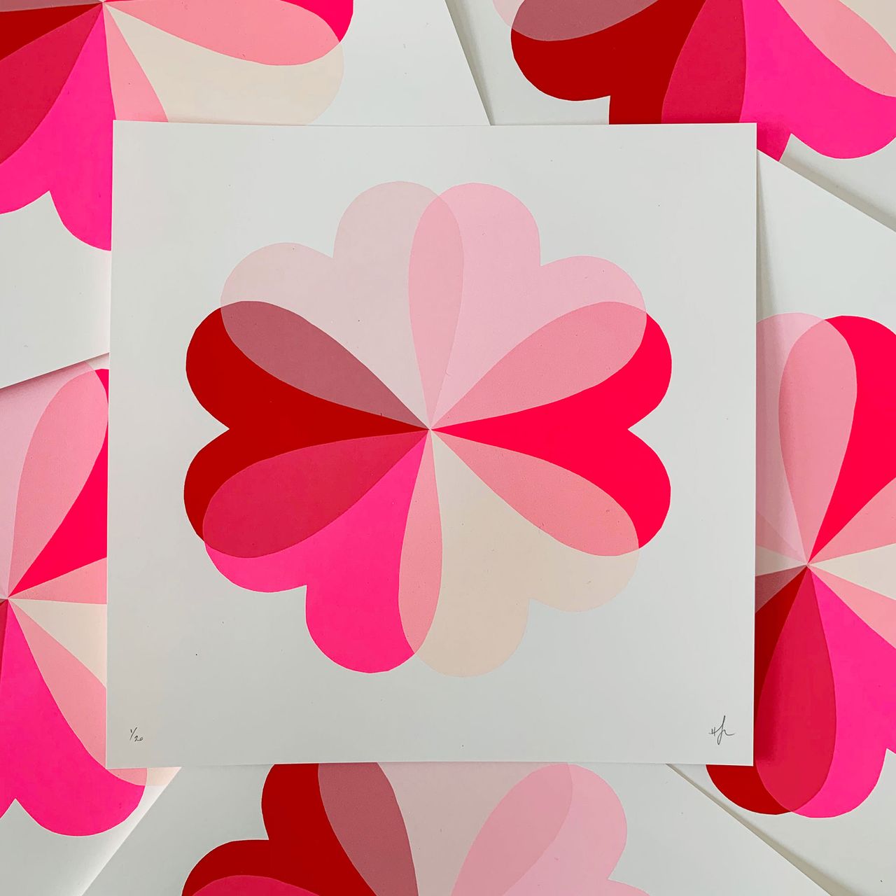 Pink graphic artwork of flower shape made up of hearts