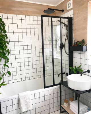 Bathroom with white grid tiling and Crittal-style shower screen