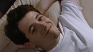 Matthew Broderick lying in bed smiling in Ferris Bueller's Day Off