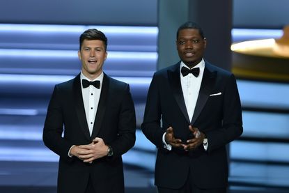 Colin Jost and Michael Che speak during the 70th Emmy Awards.