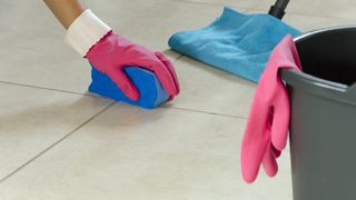 Rinsing grout on floor tile