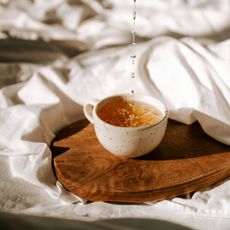 cup of tea on a white bedsheet