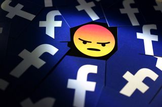 Image of an angry face emoji surrounded with a sea of Facebook logos
