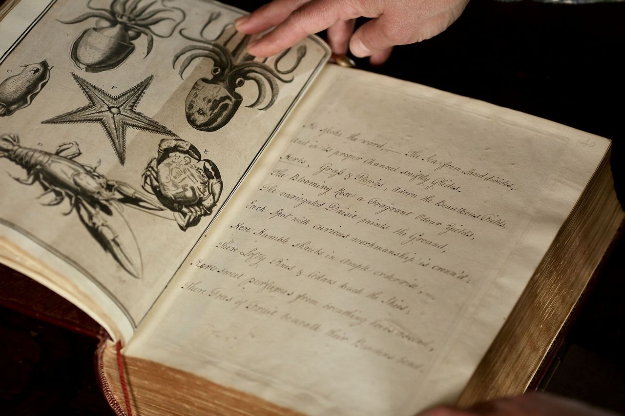 Sally Raikes and the hand-written bible at Treberfydd House in Brecon