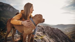 Hiker with dog on mountain