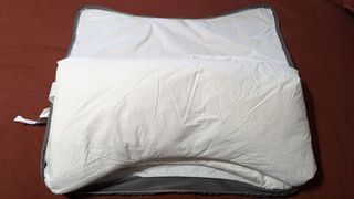 The Sleep Number NaturalFit Ultimate Pillow, with the case open showing the inner lining