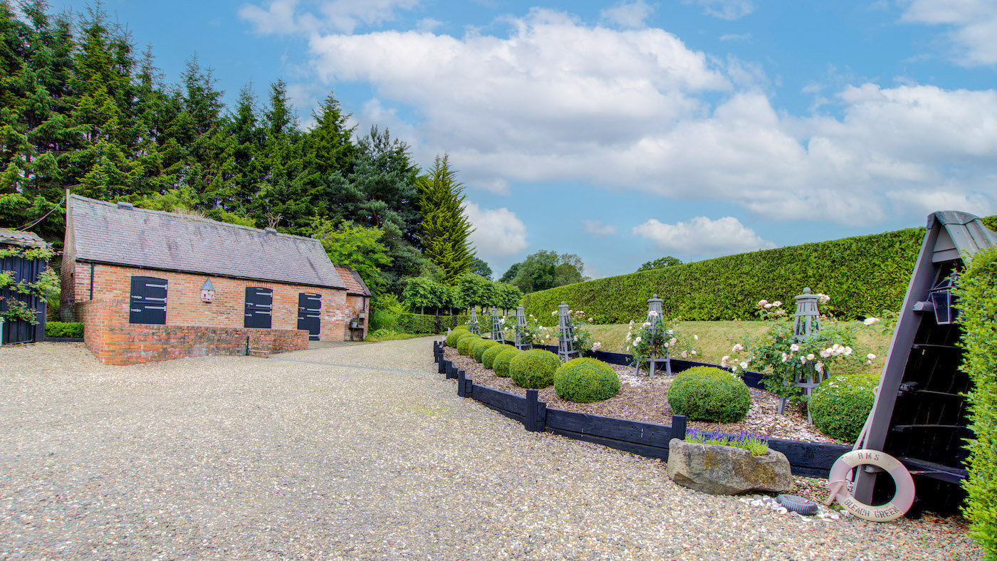 Three brick stables under a slate roof