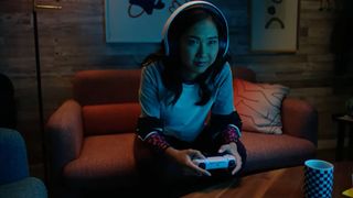 A woman plays on the Sony PS5